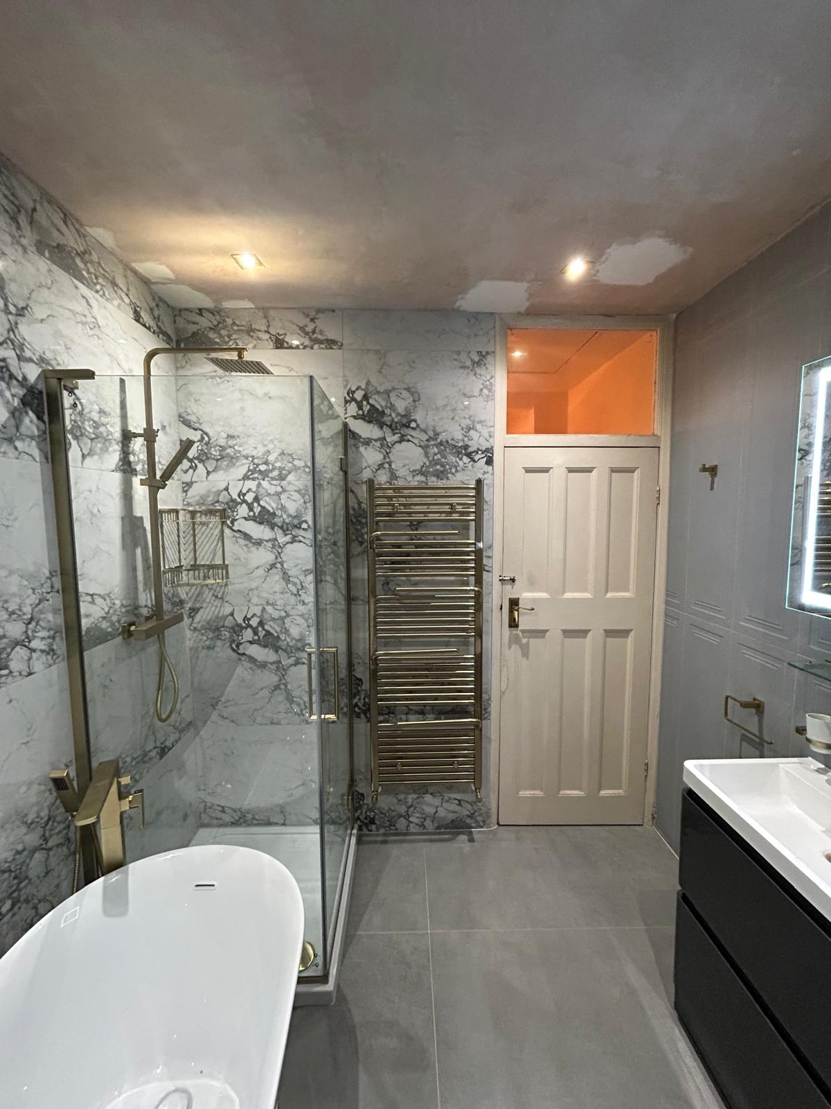 After renovation, finished shower and bath zone with brass fittings